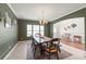 Open dining room featuring a large wooden table with seating for eight, bathed in natural light at 306 Fesperman Cir, Troutman, NC 28166