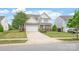 Charming two-story home with manicured lawn, stone accents, and a two-car garage at 306 Fesperman Cir, Troutman, NC 28166