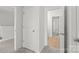 Hallway features neutral walls, carpet, and various doorways to other rooms at 306 Fesperman Cir, Troutman, NC 28166