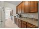 Spacious kitchen with granite countertops, wood cabinets, tile backsplash, and stainless appliances at 306 Fesperman Cir, Troutman, NC 28166