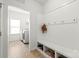 Convenient mudroom with storage bench, hooks, and direct access to the laundry area at 306 Fesperman Cir, Troutman, NC 28166