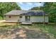 Backyard view featuring home exterior, small deck, and green lawn at 3442 Cedar Circle Rd, Lancaster, SC 29720