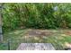 Wood deck in backyard featuring a green lawn and lush green trees at 3442 Cedar Circle Rd, Lancaster, SC 29720