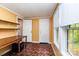 Bedroom with wood floors, a built-in wooden desk, and two windows with natural light at 3442 Cedar Circle Rd, Lancaster, SC 29720