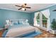Comfortable bedroom featuring natural light, ceiling fan, and light blue walls at 3442 Cedar Circle Rd, Lancaster, SC 29720