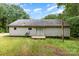 Exterior view of house with siding, a small wood deck, and sliding glass doors. Tall grass in yard at 3442 Cedar Circle Rd, Lancaster, SC 29720
