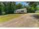 Exterior view of home showing gravel driveway, front yard, and entry ramp at 3442 Cedar Circle Rd, Lancaster, SC 29720