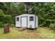 Exterior view of white and black shed with a ramp leading to the door, and windows on each side at 3442 Cedar Circle Rd, Lancaster, SC 29720