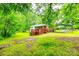 Lush backyard featuring a deck, mature trees, and ample green space at 3491 Mcconnells Hwy, Rock Hill, SC 29732