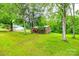 View of the home from the backyard, surrounded by trees and lawn at 3491 Mcconnells Hwy, Rock Hill, SC 29732