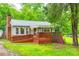 Charming single-story home with a wooden porch and wheelchair ramp, surrounded by lush greenery at 3491 Mcconnells Hwy, Rock Hill, SC 29732