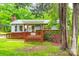 Inviting front exterior of a light blue home with a cozy covered porch and mature trees at 3491 Mcconnells Hwy, Rock Hill, SC 29732