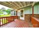 Close-up of a charming front porch with a wooden railing and a white door, offering curb appeal at 3491 Mcconnells Hwy, Rock Hill, SC 29732