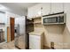 Compact kitchen features stainless steel refrigerator and microwave at 3491 Mcconnells Hwy, Rock Hill, SC 29732