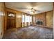 Spacious living room with a brick fireplace, wood paneling, and a bright window view at 3491 Mcconnells Hwy, Rock Hill, SC 29732