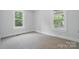 Bedroom featuring neutral carpet, and two windows at 410 E 17Th St, Kannapolis, NC 28083