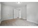 Bedroom featuring neutral carpet, two windows and an adjoining room at 410 E 17Th St, Kannapolis, NC 28083