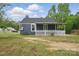Charming home with navy siding, a white picket fence, and a covered porch at 410 E 17Th St, Kannapolis, NC 28083