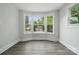 Bright living room featuring large windows and wood-look floors at 410 E 17Th St, Kannapolis, NC 28083