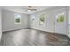 Bright living room with sleek floors, large windows, and a modern ceiling fan at 410 E 17Th St, Kannapolis, NC 28083