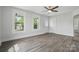 Bright living room with sleek floors, large windows, and a modern ceiling fan at 410 E 17Th St, Kannapolis, NC 28083