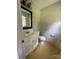 Cozy bathroom featuring a vanity with mirror, toilet, and patterned flooring at 5008 Delivau Dr, Charlotte, NC 28215