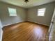Comfortable bedroom with hardwood floors, neutral walls, and windows for ample natural light at 5008 Delivau Dr, Charlotte, NC 28215