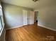 Bedroom features hardwood floors and a closet at 5008 Delivau Dr, Charlotte, NC 28215