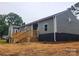 Back exterior view, featuring updated paint, a small deck, and a star detail on the siding at 501 N Hawthorne St, Mount Holly, NC 28120