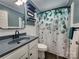 This bathroom features a shower, vanity, black faucet, and eucalyptus shower curtain at 501 N Hawthorne St, Mount Holly, NC 28120