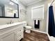 Bathroom featuring a vanity, toilet, and tub shower with blue shower curtain at 501 N Hawthorne St, Mount Holly, NC 28120
