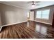Bedroom featuring wood-look floors, neutral walls, modern light fixture, and natural light at 501 N Hawthorne St, Mount Holly, NC 28120