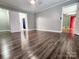 Bedroom featuring wood-look floors, neutral walls, and modern light fixture at 501 N Hawthorne St, Mount Holly, NC 28120