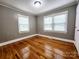 This bedroom features hardwood floors, neutral paint, and a light fixture at 501 N Hawthorne St, Mount Holly, NC 28120