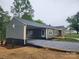 Beautiful exterior featuring a charming facade, covered parking, and well-maintained gravel driveway at 501 N Hawthorne St, Mount Holly, NC 28120