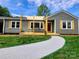 Charming one-story home with a welcoming front porch and a freshly painted walkway at 501 N Hawthorne St, Mount Holly, NC 28120