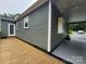 Charming home with modern gray siding, a spacious wooden deck, and a convenient carport at 501 N Hawthorne St, Mount Holly, NC 28120