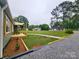 Charming home with lush front yard and gravel driveway at 501 N Hawthorne St, Mount Holly, NC 28120