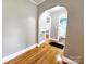 Hallway with hardwood floors, arched entryway, and built-in niche, enhancing the home's vintage appeal at 501 N Hawthorne St, Mount Holly, NC 28120