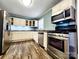 Updated kitchen features stainless steel appliances, white cabinets, and modern countertops at 501 N Hawthorne St, Mount Holly, NC 28120