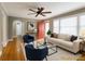 Cozy living room with hardwood floors, neutral walls, and stylish furnishings under a ceiling fan at 501 N Hawthorne St, Mount Holly, NC 28120