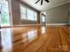 Living room showcasing hardwood floors, large windows, and an arched doorway, creating a bright and inviting space at 501 N Hawthorne St, Mount Holly, NC 28120