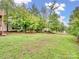 Large, grassy backyard surrounded by mature trees offering privacy at 6758 Zion Church Rd, Concord, NC 28025