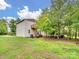 Backyard exterior featuring a cozy deck overlooking a well-maintained yard and surrounding trees at 6758 Zion Church Rd, Concord, NC 28025