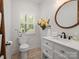 Elegant bathroom featuring a decorative flower wall hanging and decorative mirror at 6758 Zion Church Rd, Concord, NC 28025