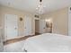 Bright bedroom features a decorative chandelier and ensuite bathroom access, enhancing its appeal at 6758 Zion Church Rd, Concord, NC 28025