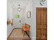 Bright entryway with wooden bench, decorative light fixture, and unique wooden door at 6758 Zion Church Rd, Concord, NC 28025