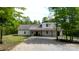 Charming exterior of the two-story home with a gravel driveway and covered porch at 6758 Zion Church Rd, Concord, NC 28025
