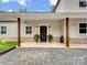 Inviting front porch with wooden columns and decorative sconce lighting at 6758 Zion Church Rd, Concord, NC 28025