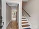 Hallway with stairs leading to the upper level and a view into another room at 6758 Zion Church Rd, Concord, NC 28025